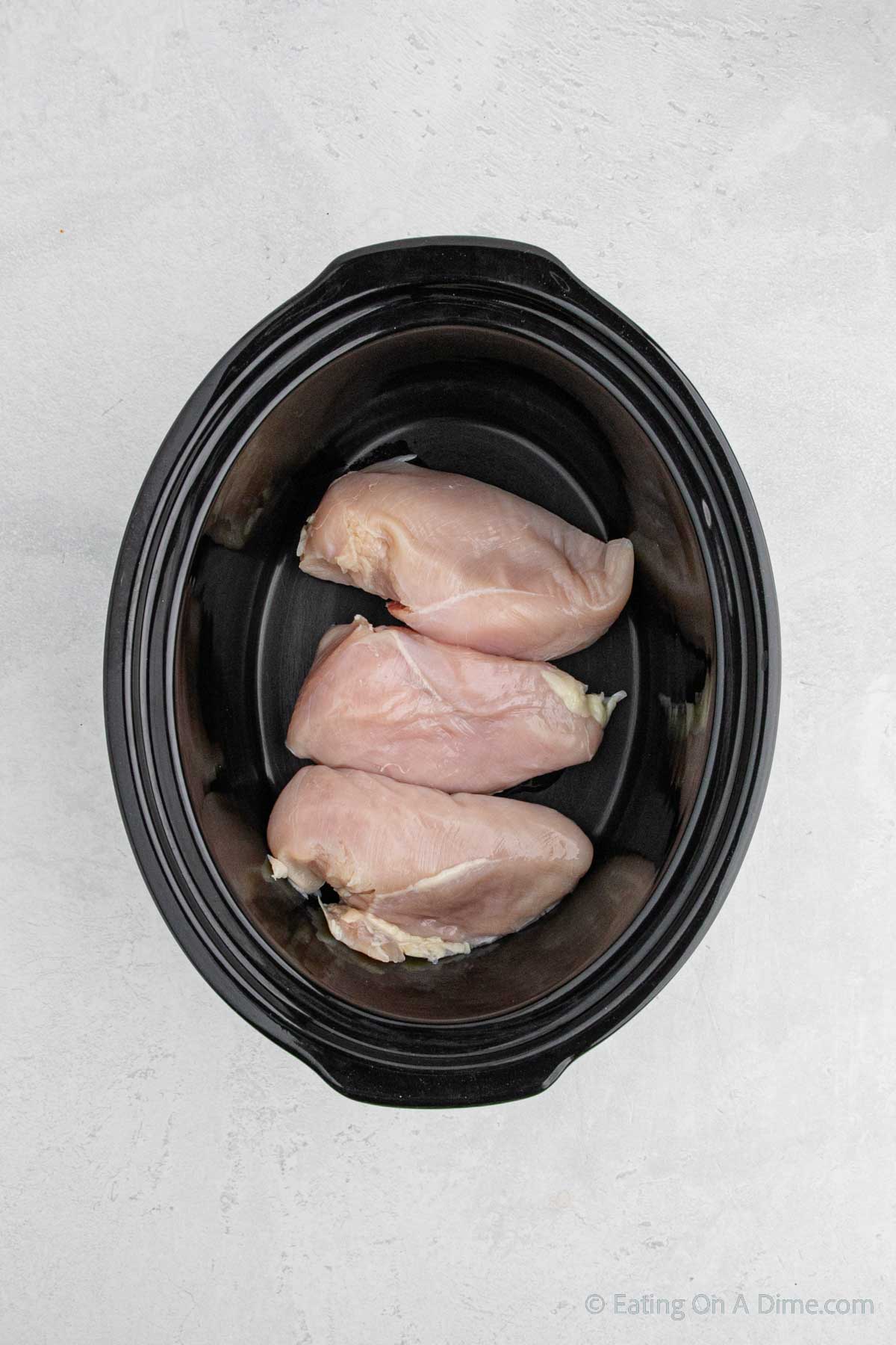 Placing the chicken breasts in the slow cooker