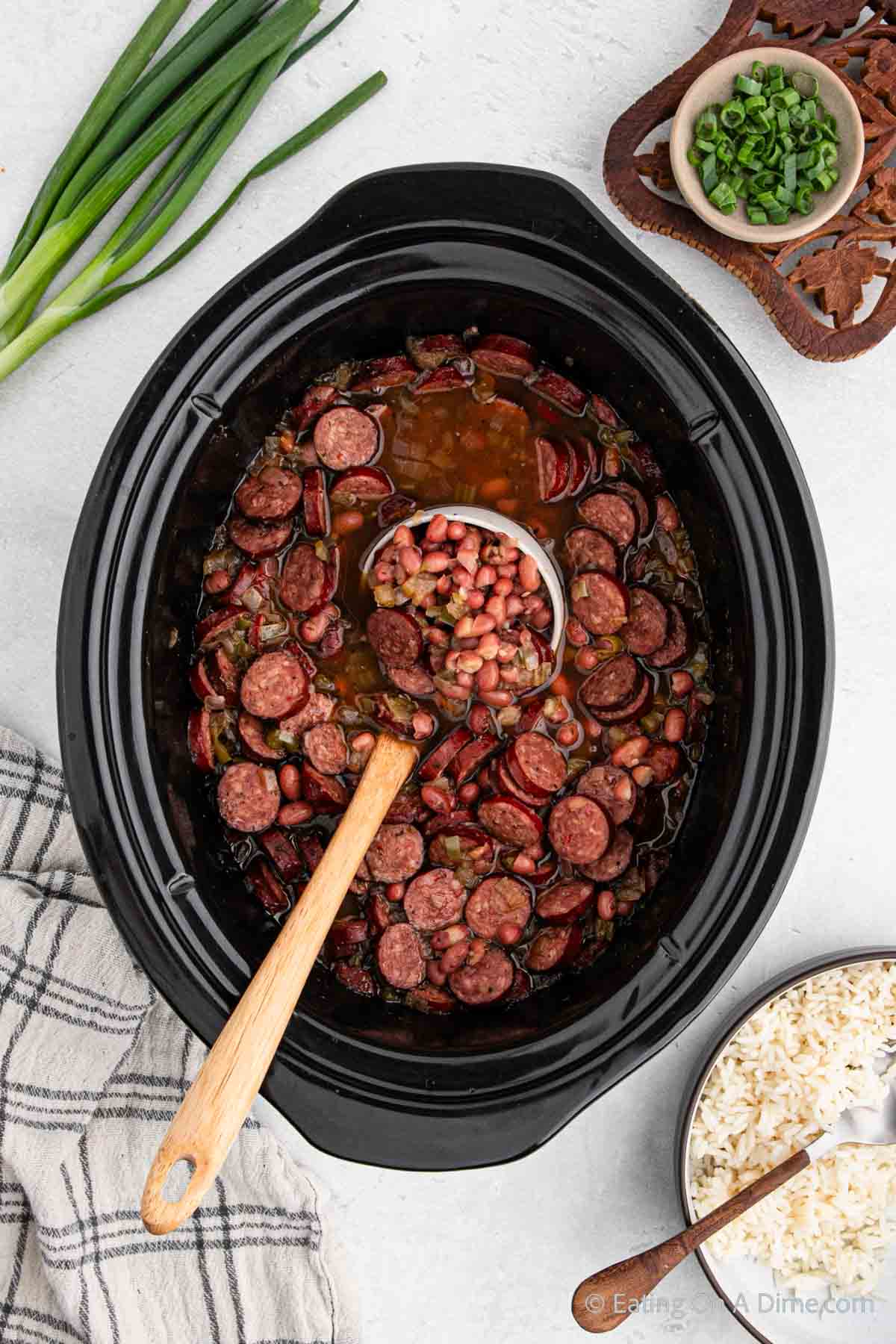 Red beans and rice in the slow cooker with a serving on a ladle