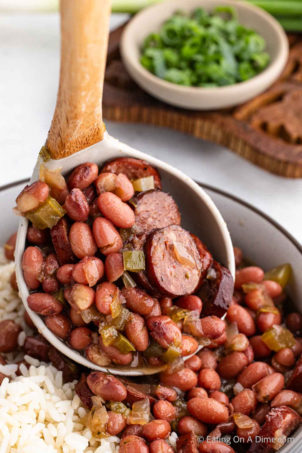 Red beans and rice in a bowl with a serving on a ladle