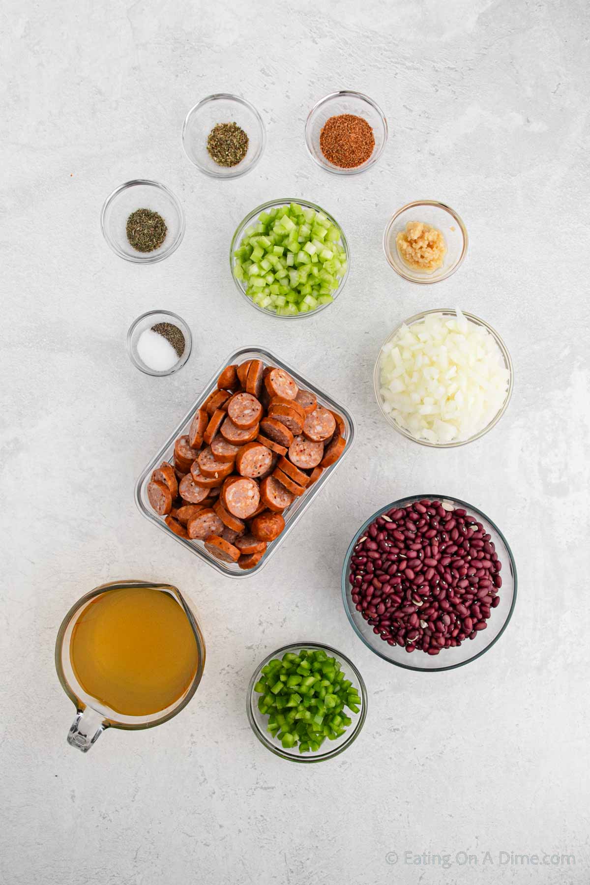 Red beans and rice ingredients - red beans, sausage, bell pepper, celery, chicken broth, onion, seasoning, garlic, thyme oregano