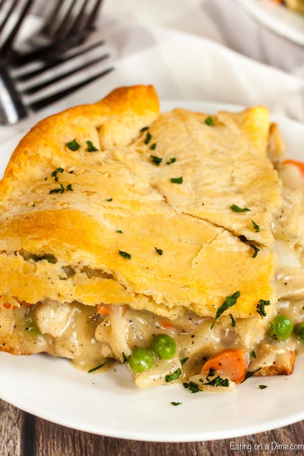 Close up image of a serving of chicken pot pie casserole in a white plate. 