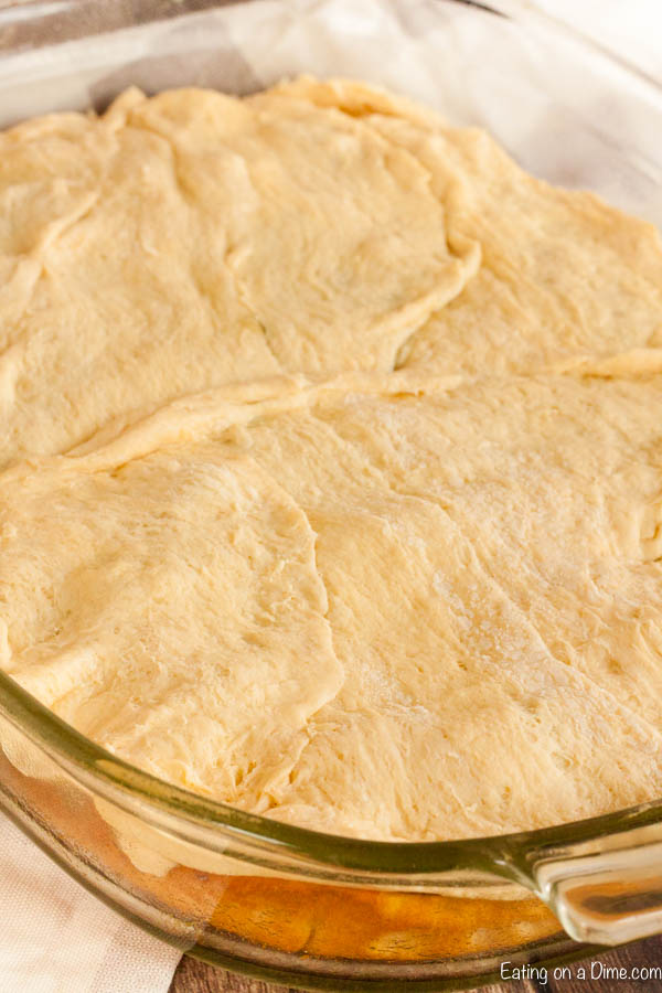 Close up image of uncooked chicken pot pie in a baking dish. 