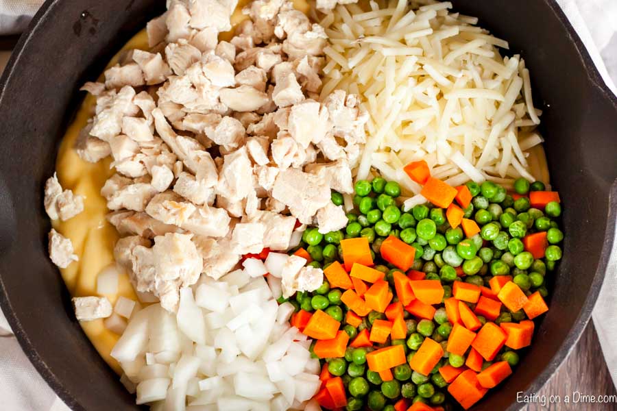 Closer up image of uncooked ingredients in a iron skillet. 