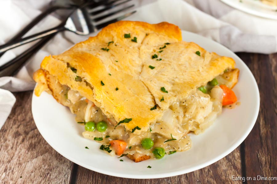 Close up image of a serving of chicken pot pie on a white plate. 