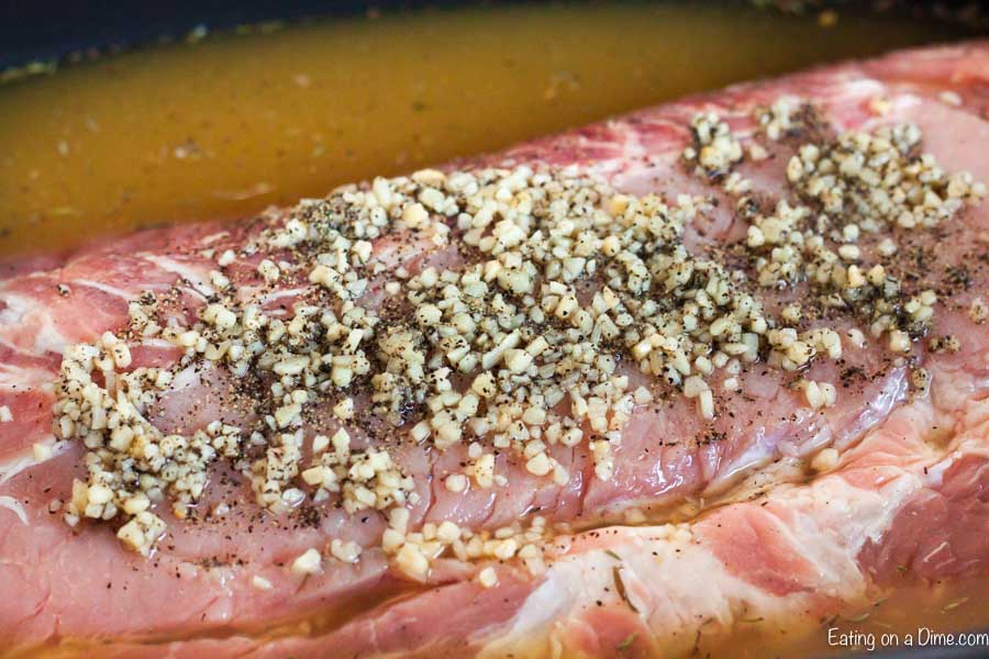 Crock Pot Pork Loin Recipe is so tender and flavorful. Top each slice of boneless crock pot pork loin roast with gravy for the best comfort food. Crock pot pork loin slow cooker is easy and delicious. #eatingonadime #crockpotporkloinroastrecipe #recipeseasy