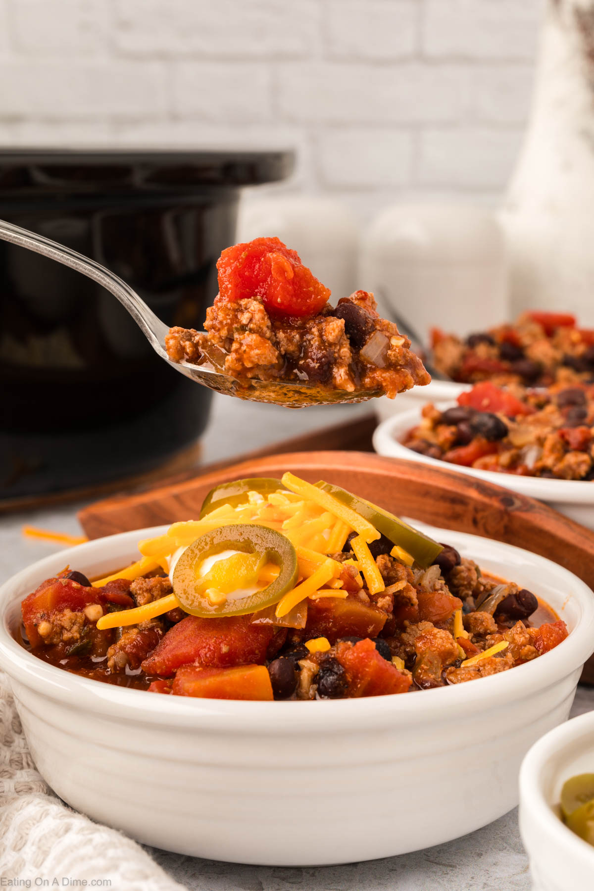 Chipotle Chili in a white bowl with a bite on a spoon