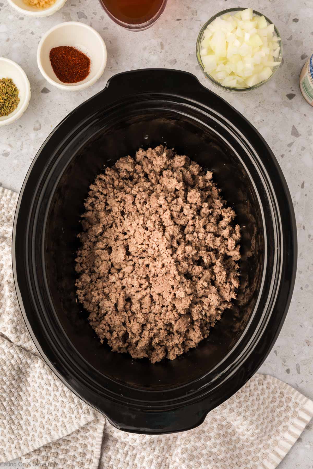Placing the ground beef in the slow cooker