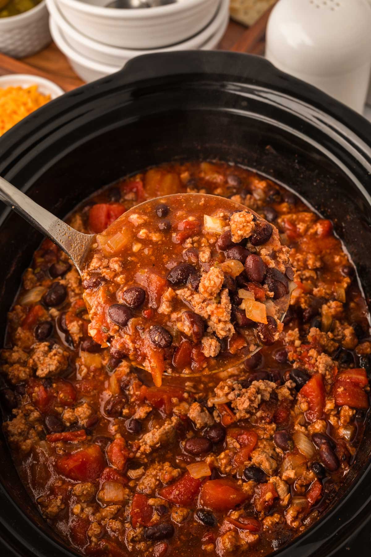 Chipotle Chili in a slow cooker with a serving on a ladle