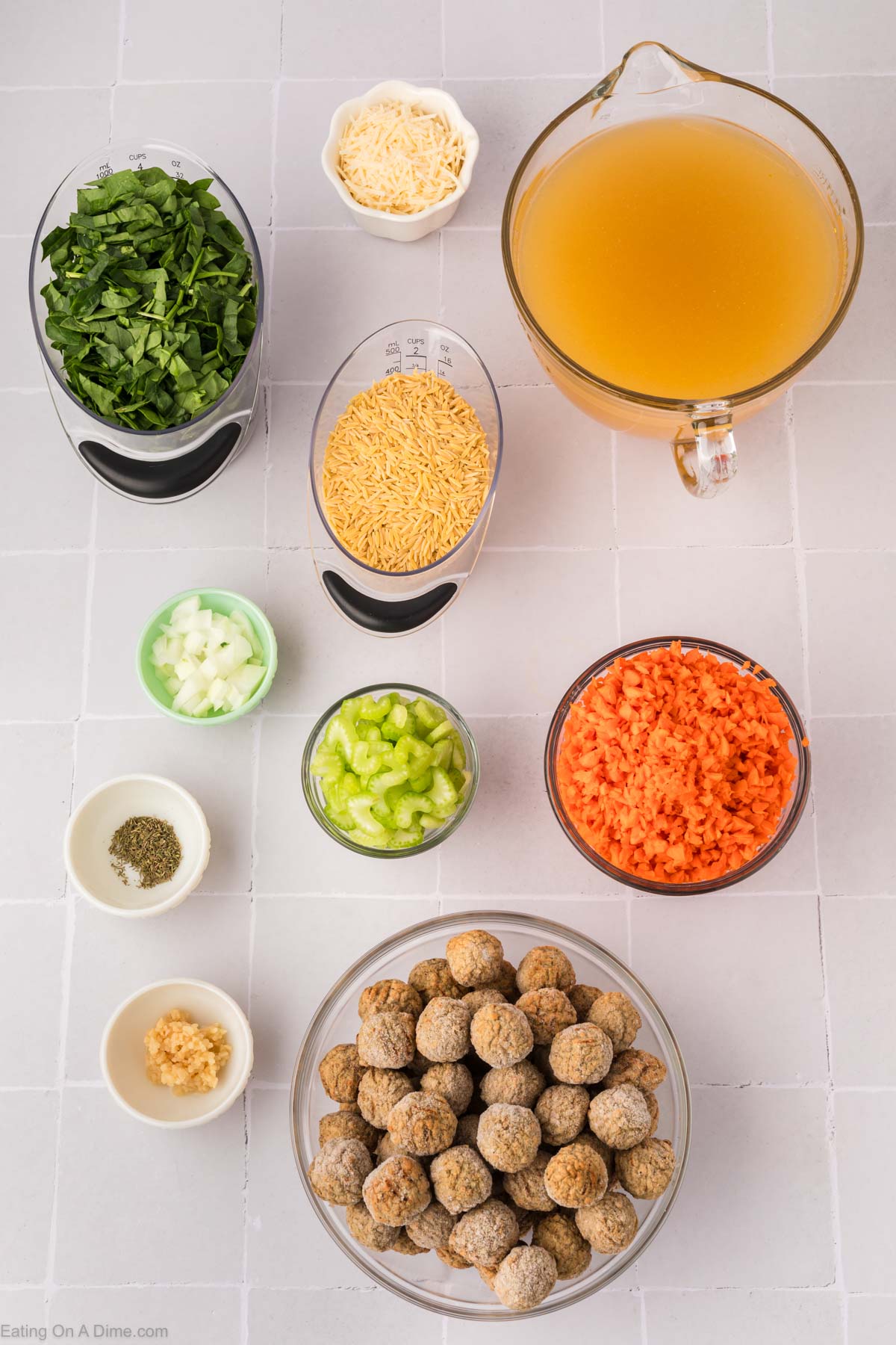 Italian Wedding Soup ingredients - chicken meatballs, onion, carrots, celery, garlic, thyme, broth, orzo pasta, spinach, parmesan cheese