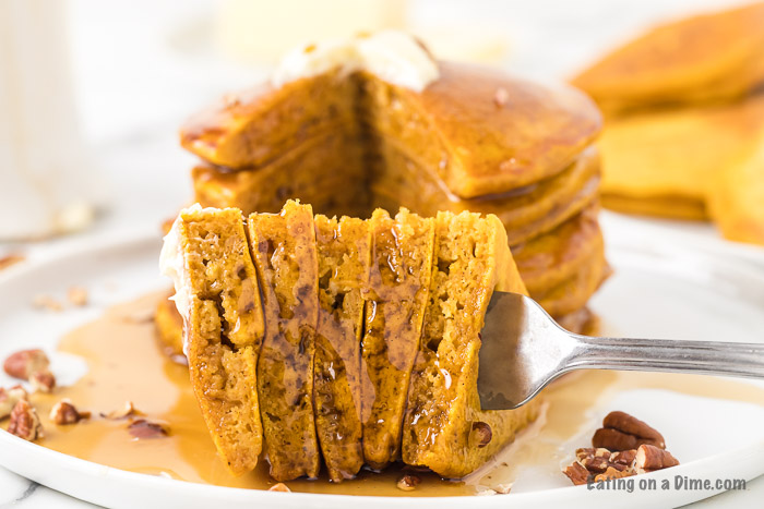 Close up image of pumpkin pancakes stacked and on a fork. 