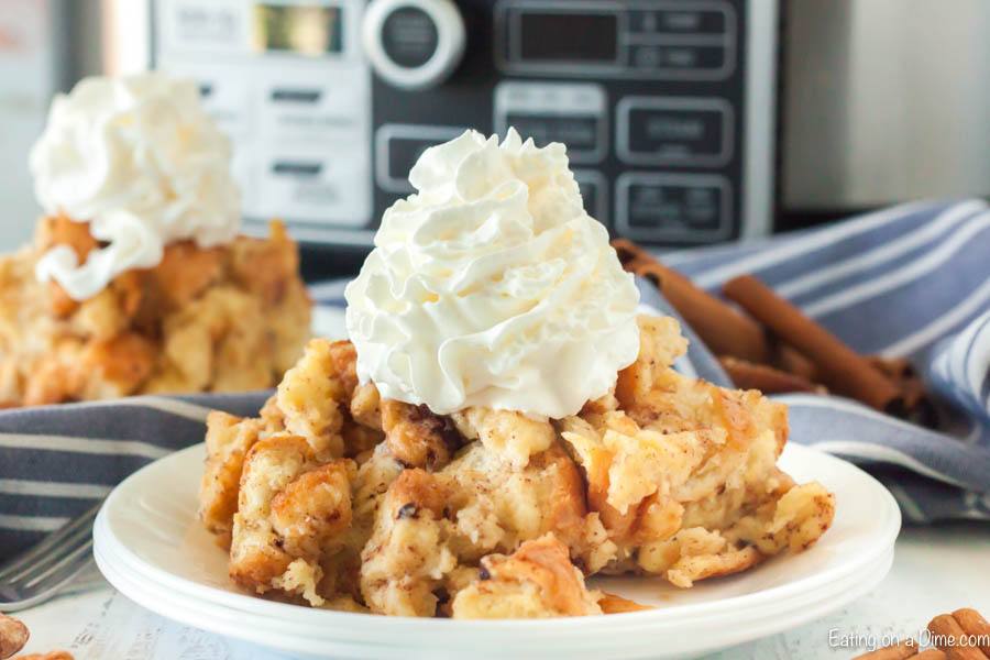 Bread pudding on a plate topped with ready whip.  