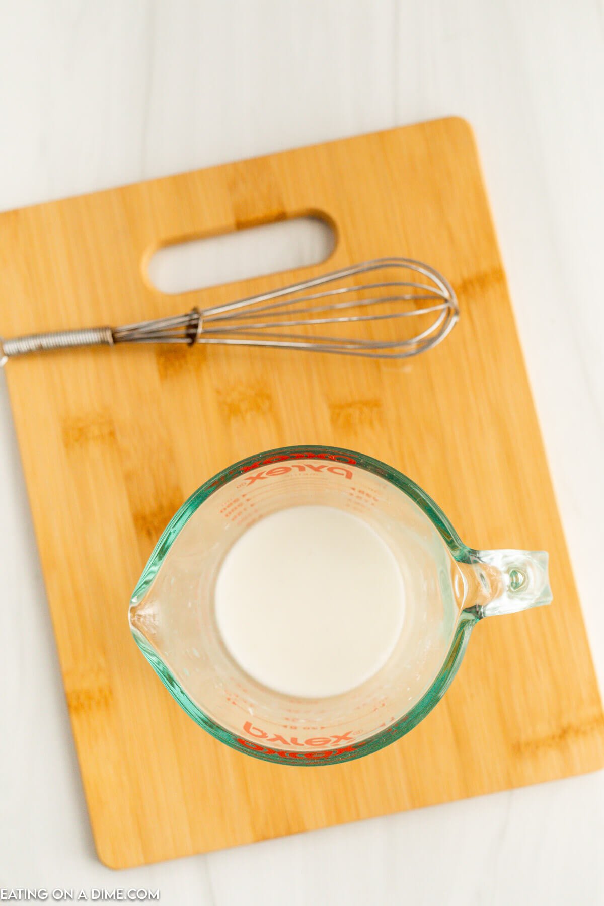 Mixing the cornstarch and water in a measuring cup