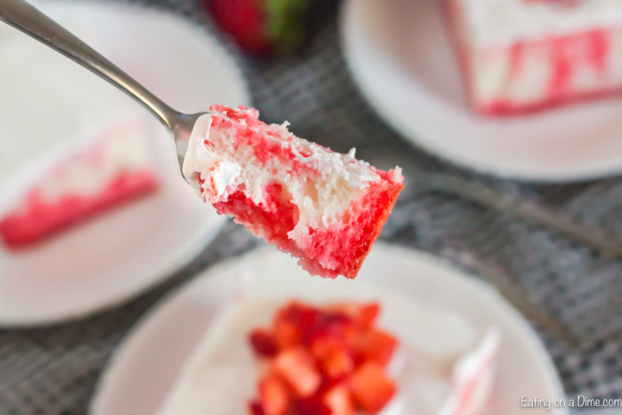 Close up image of a serving on a fork of Strawberry Jello Cake. 