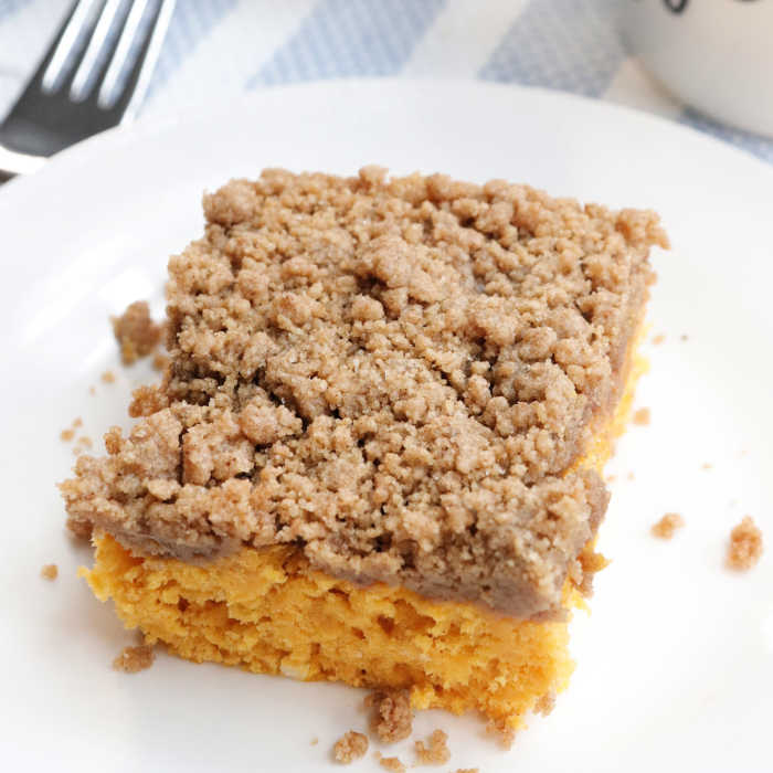 This Pumpkin Coffee Cake Recipe is going to be a hit! Cake mix paired with pumpkin and streusel topping creates a delicious cake for breakfast or dessert. 
