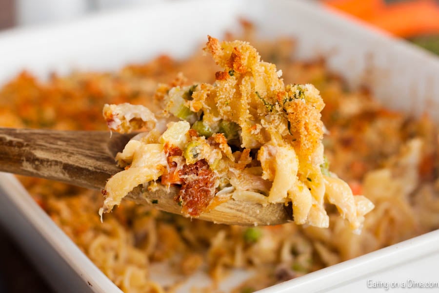 Tuna casserole with a serving on a wooden spoon. 