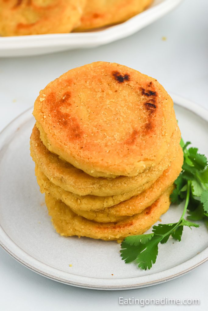 Arepas stacked on a plate
