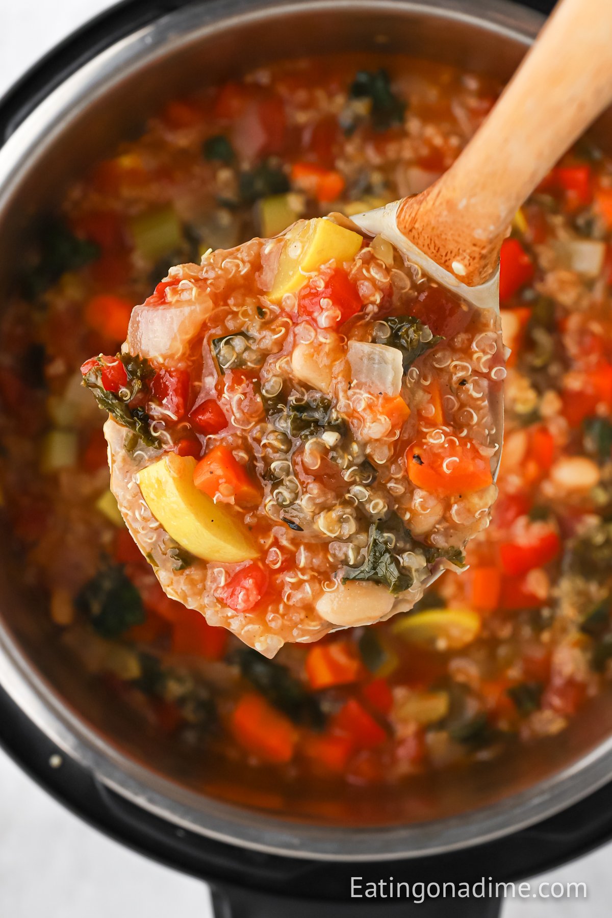 Quinoa Soup in the instant pot with a serving on a ladle