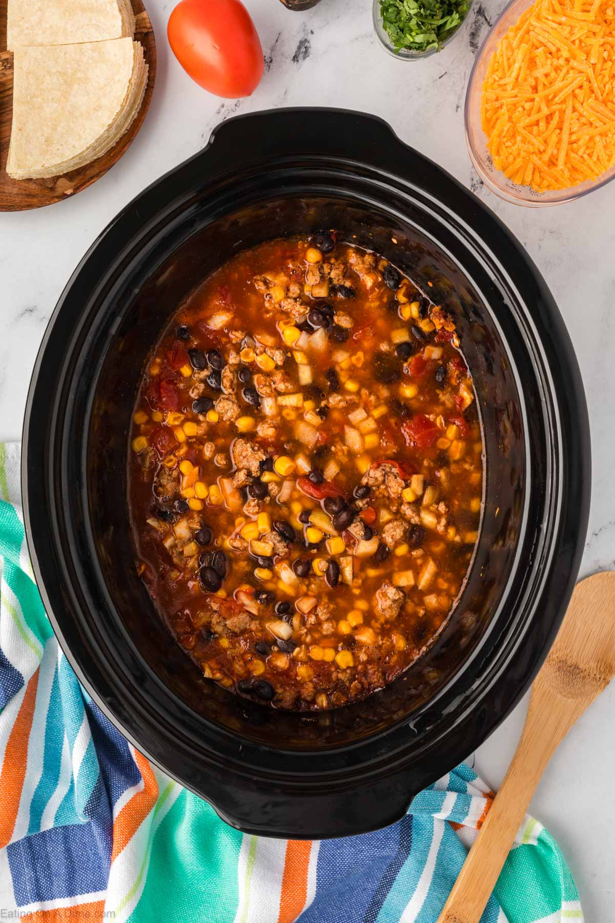 Stirring the Mexican Casserole ingredients in a slow cooker