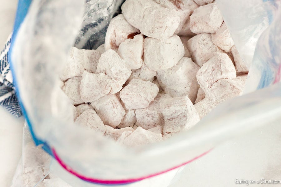 Close up image of pork chunks in a bag with flour.