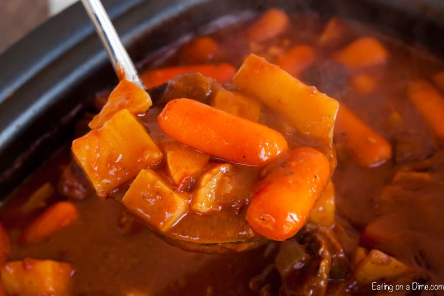 Ladle of Irish beef stew in crockpot.