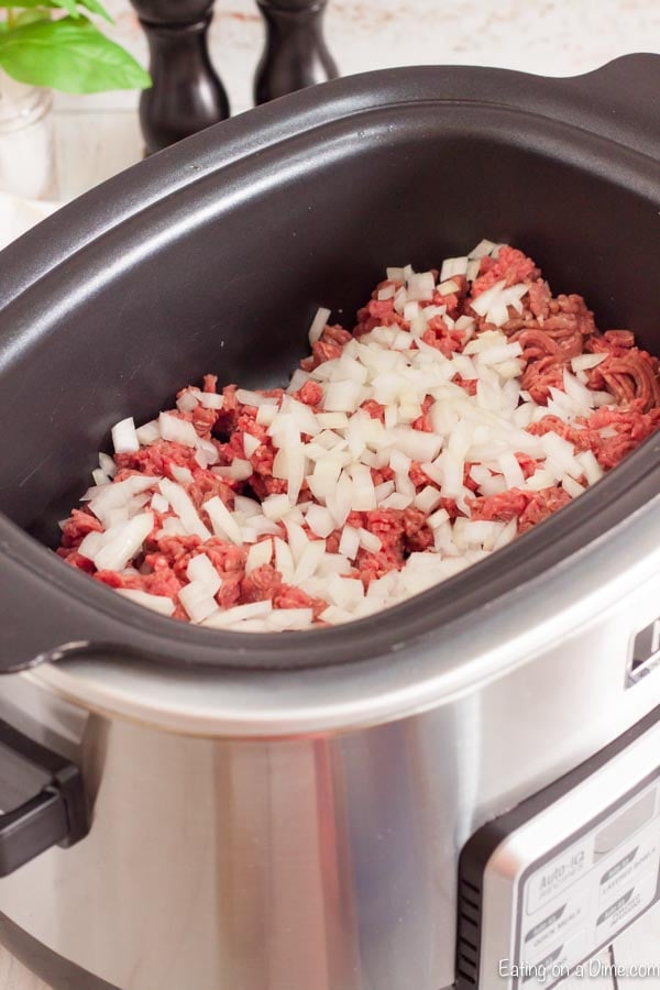 Cooking the beef in a slow cooker with chopped onions