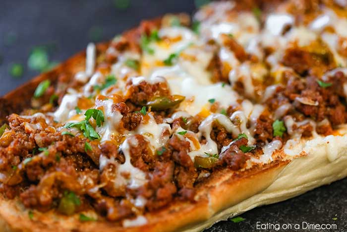 Sloppy joes stuffed french bread recipe has everything you love about sloppy joes in a cheese stuffed bread. This is the perfect party food or dinner idea.