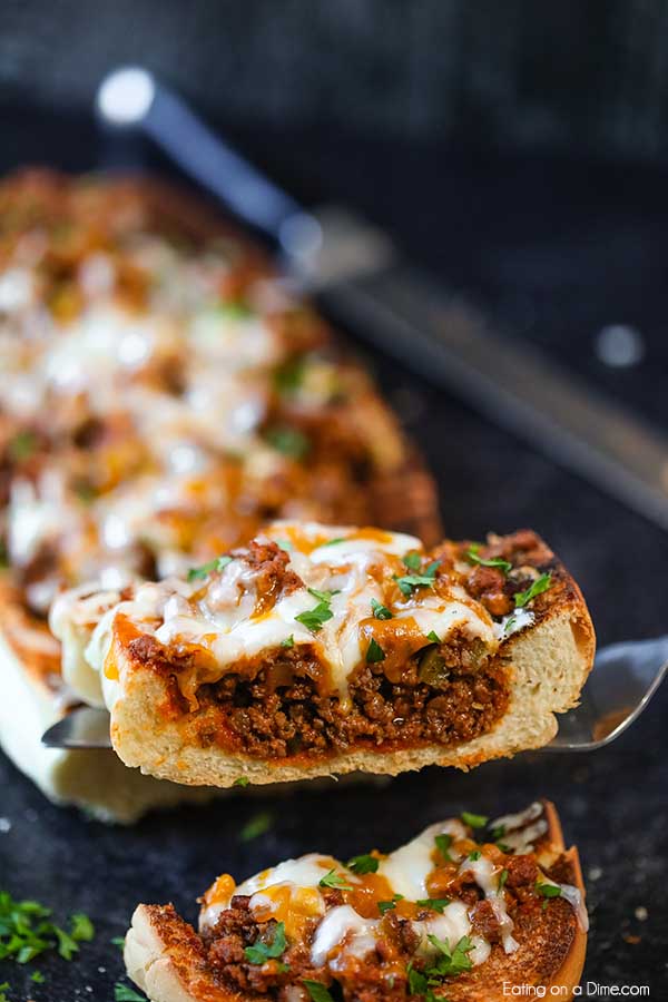 Sloppy joes stuffed french bread recipe has everything you love about sloppy joes in a cheese stuffed bread. This is the perfect party food or dinner idea.
