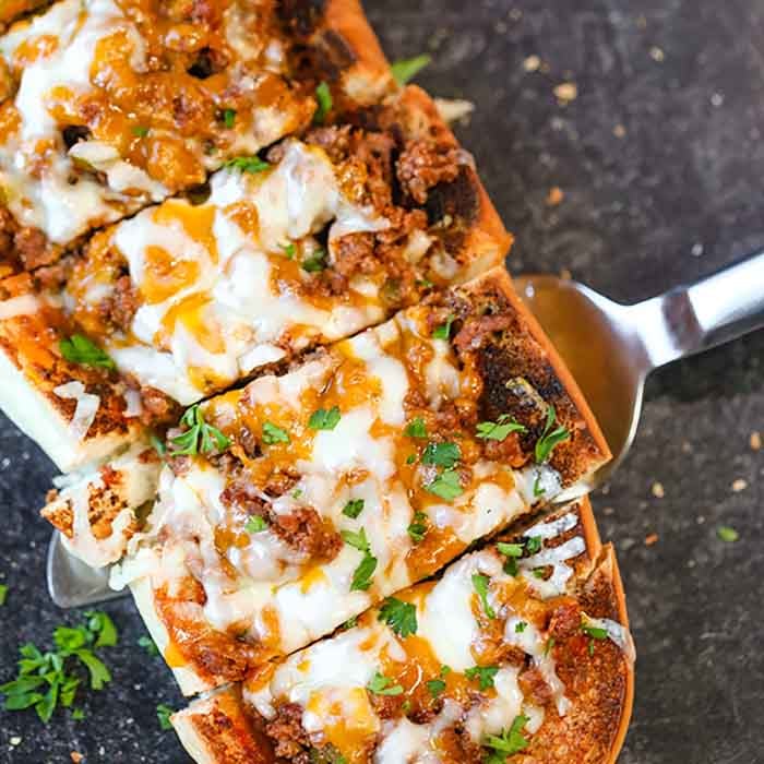 Sloppy joes stuffed french bread recipe has everything you love about sloppy joes in a cheese stuffed bread. This is the perfect party food or dinner idea.