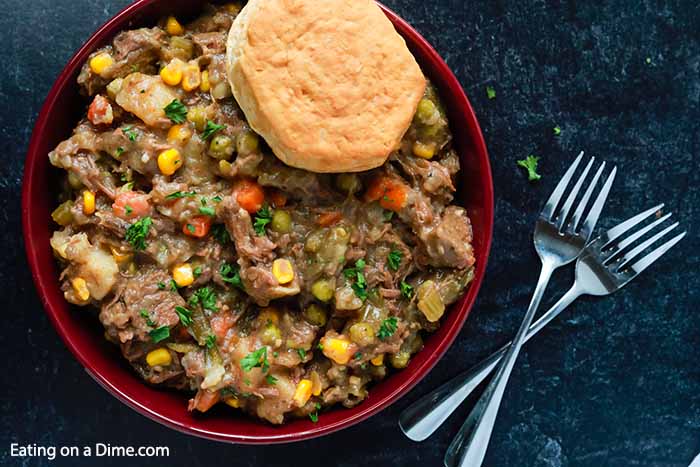 Try this twist on the classic recipe when you make Crock pot beef pot pie recipe. The beef is a nice change and adds a lot of flavor to the veggies. The slow cooker makes the best homemade beef pot pie and so easy. #eatingonadime #crockpotbeefpotpie