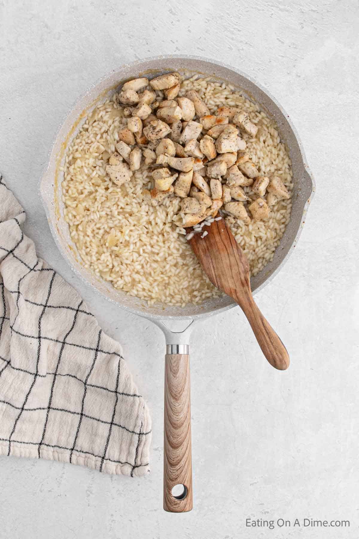 Adding in the diced cooked chicken in a skillet