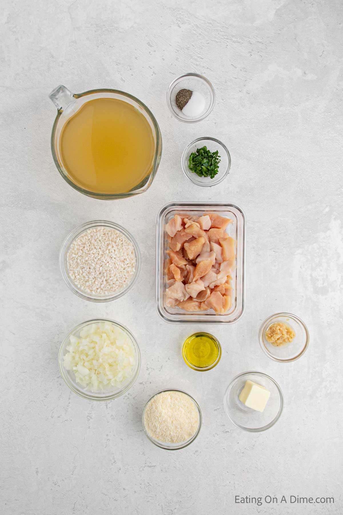 Chicken risotto ingredients - olive oil, chicken breasts, salt and pepper, onion, garlic, rice, chicken broth, parmesan cheese, butter, parsley