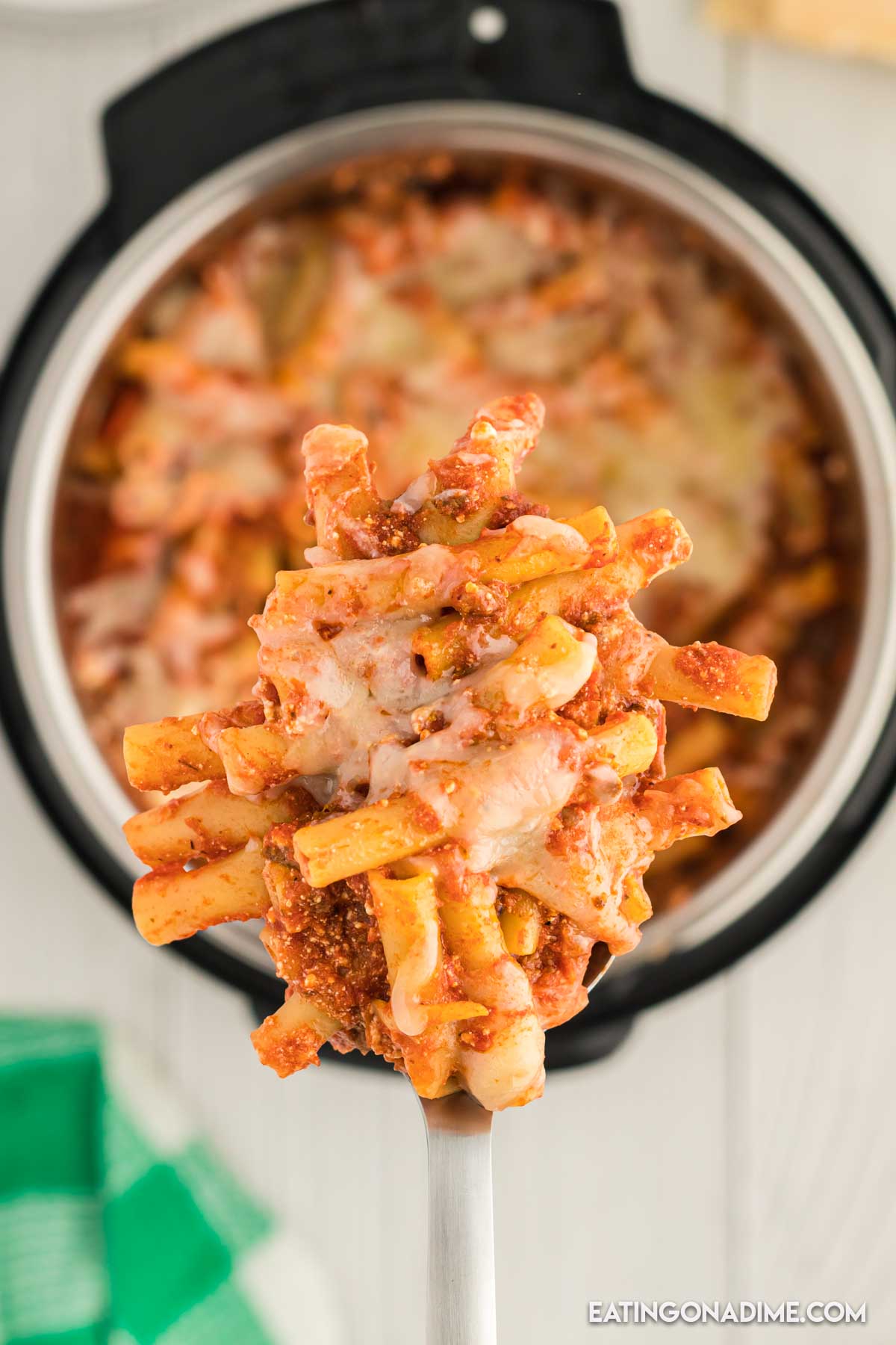 A serving of baked ziti on a spoon