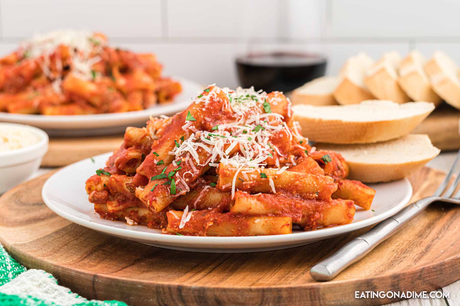 Close up image of baked ziti on a white plate.