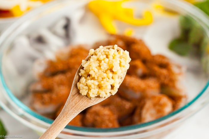 Close up image of a teaspoon of minced garlic