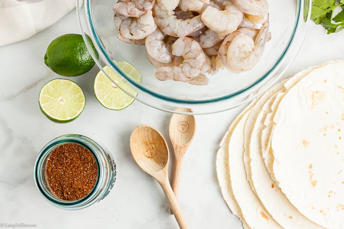 Sheet Pan Shrimp Fajitas Ingredients - Shrimp, fajita seasoning, garlic, salt, olive oil, bell peppers, onion, limes, cilantro