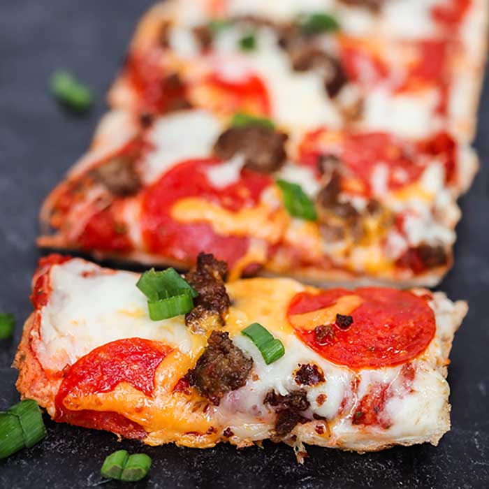 Homemade French Bread Pizza Recipe is perfect any day of the week. Throw this together in minutes for a dinner everyone will love.