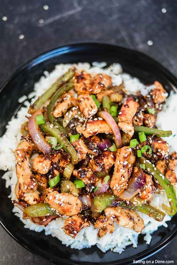 Close up image of black pepper chicken on rice. 
