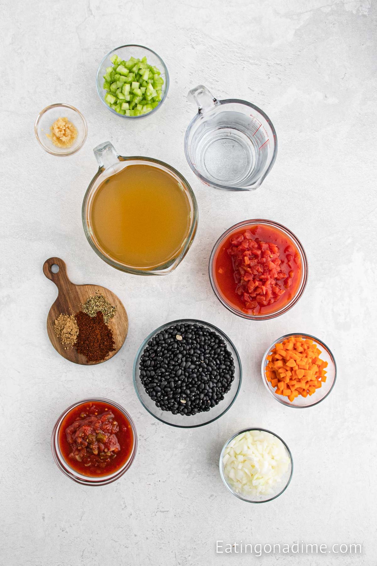 Ingredients needed for Black Beans Soup - Minced garlic, onion, celery, carrots, black beans, salsa, chili powder, cumin, dried oregano, broth, water, diced tomatoes, bay leaves
