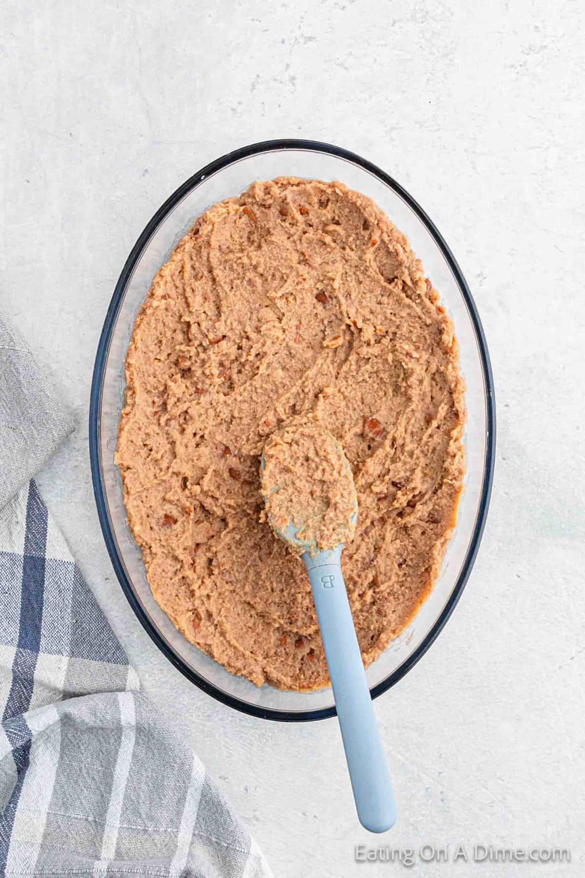 Spread refried beans spread in a clear dish