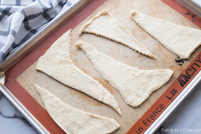 Separating the crescent rolls on a baking sheet
