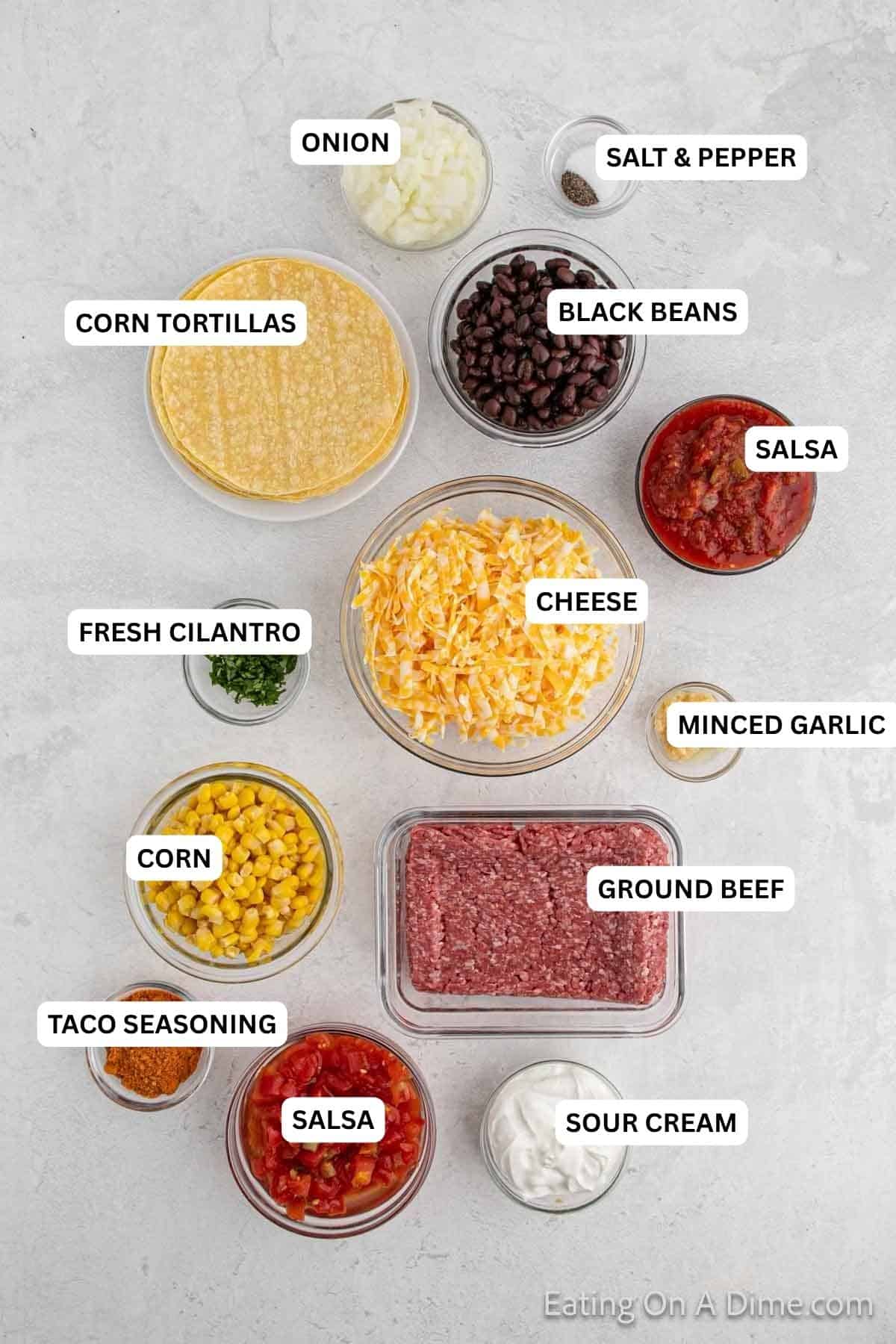 Ingredients for recipe: Ground beef, onion, minced garlic, taco seasoning, salt, pepper, black beans, corn, diced tomatoes, salsa, cheese, corn tortillas, sour cream, fresh cilantro.