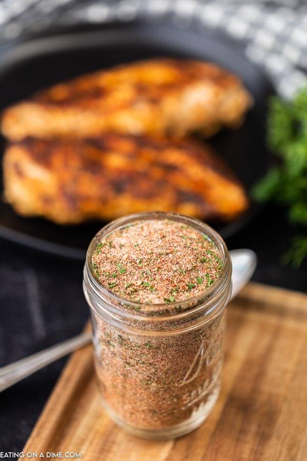 Overview of homemade blackened seasoning with chicken in the background.  