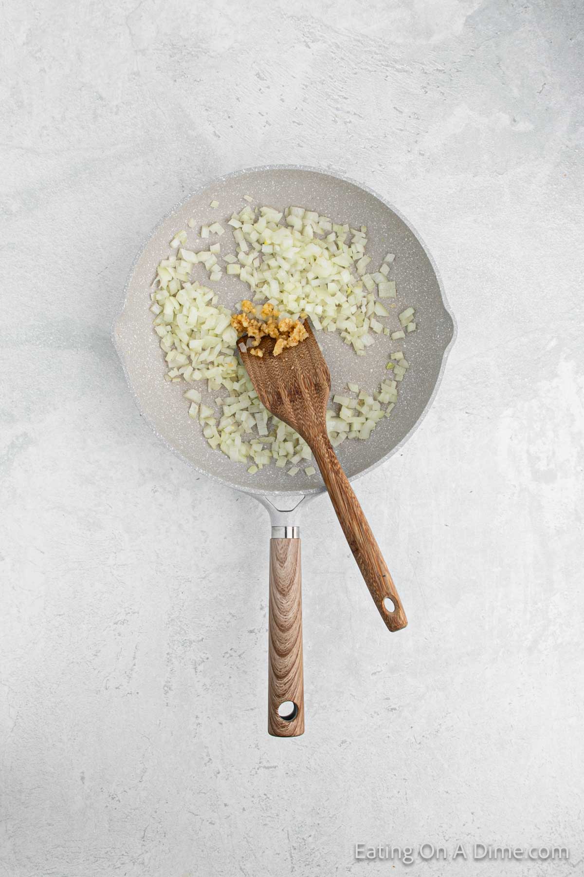 The onion and garlic being sautéd in a skillet until soft.  