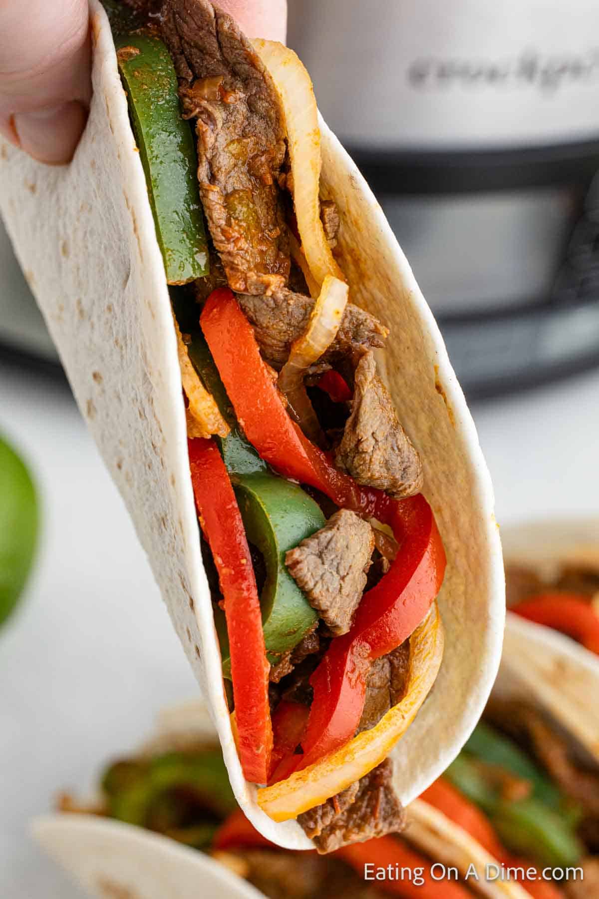 Close up image of Steak fajitas wrapped in a flour tortilla