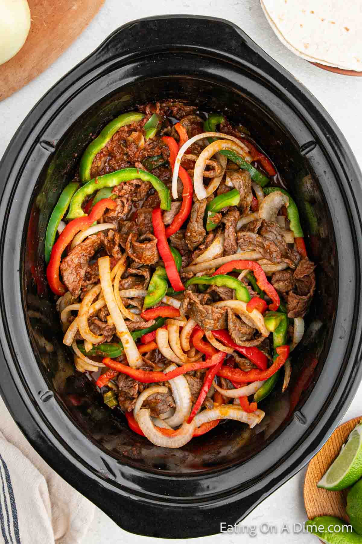 Steak fajitas in the slow cooker with peppers and onions