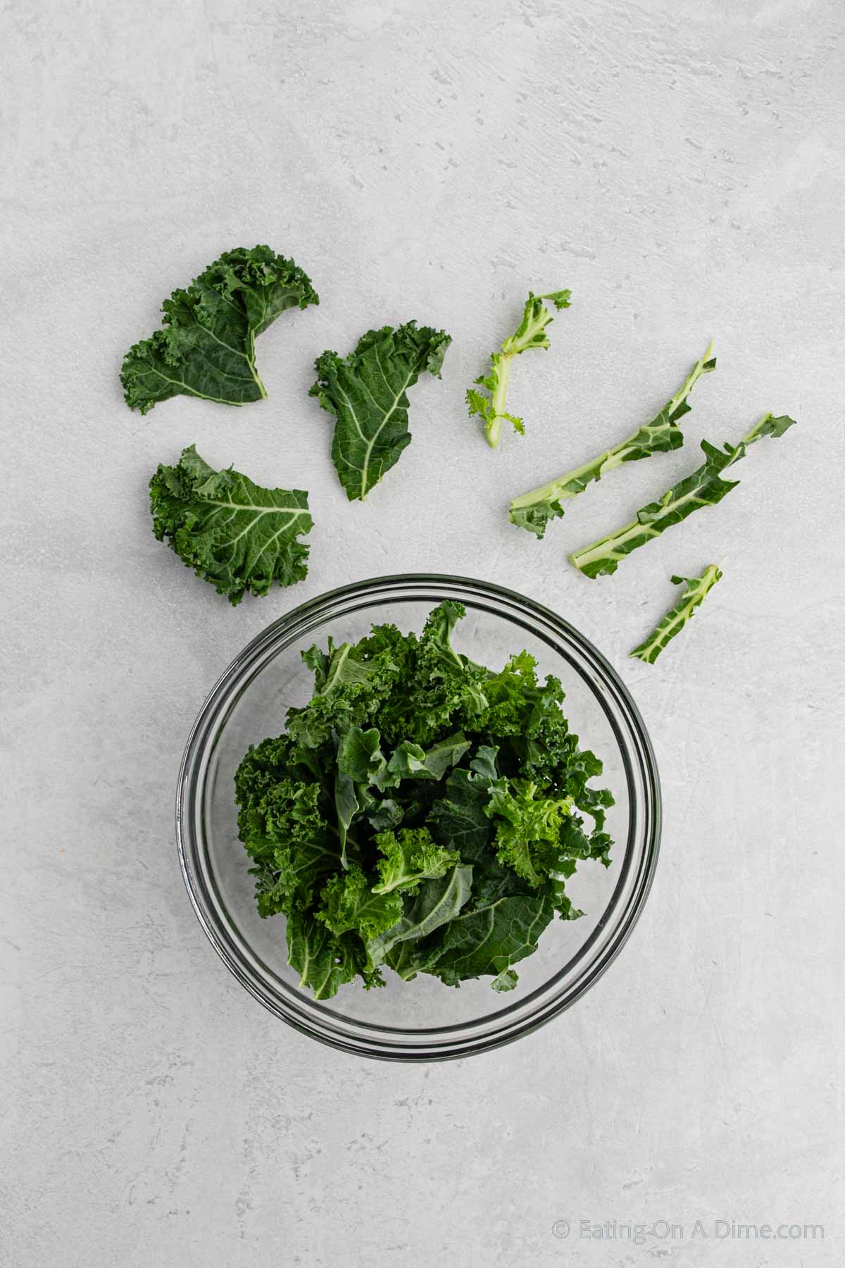 Cut the kale into bite size pieces and removing the stems