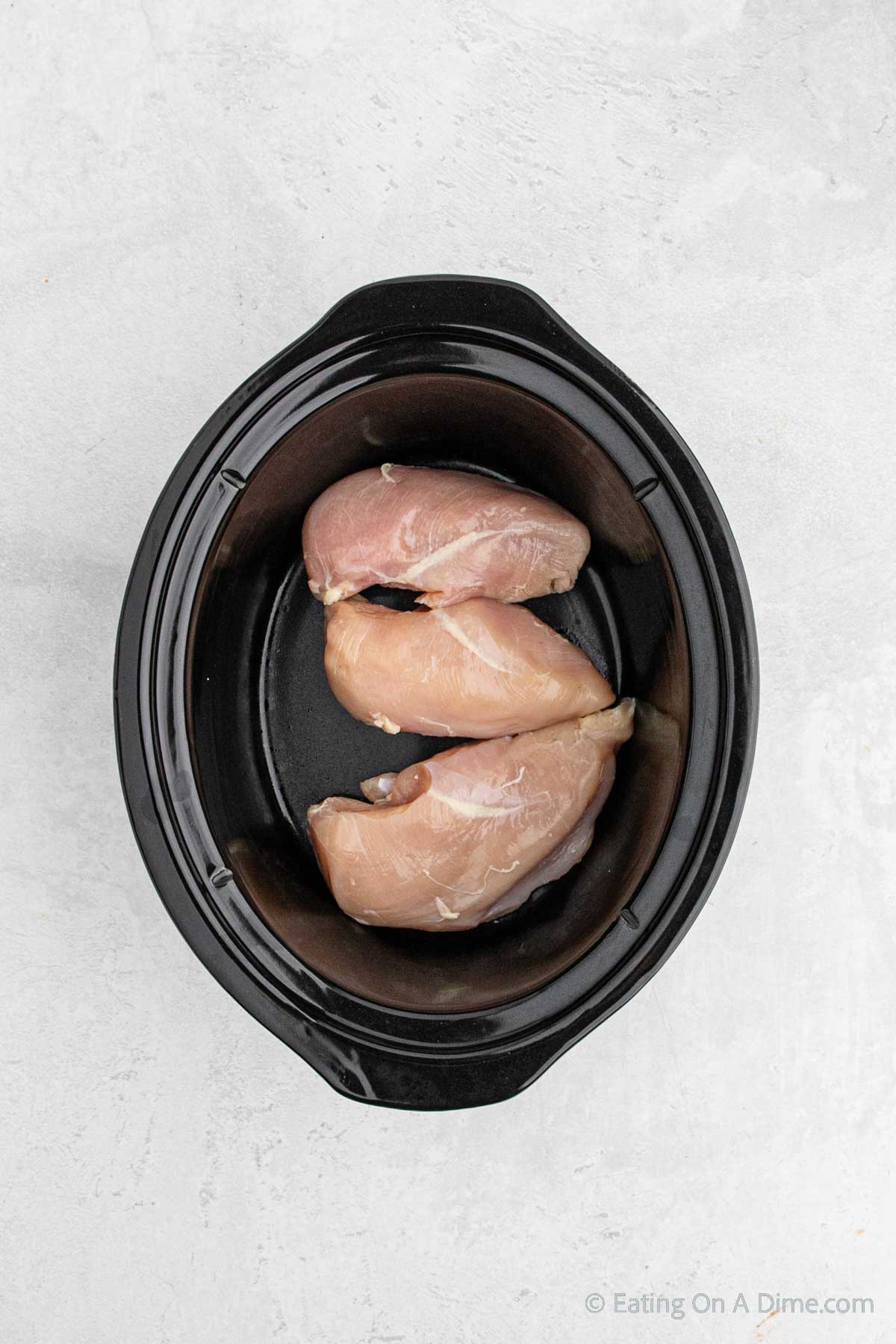 Placing the chicken in the slow cooker