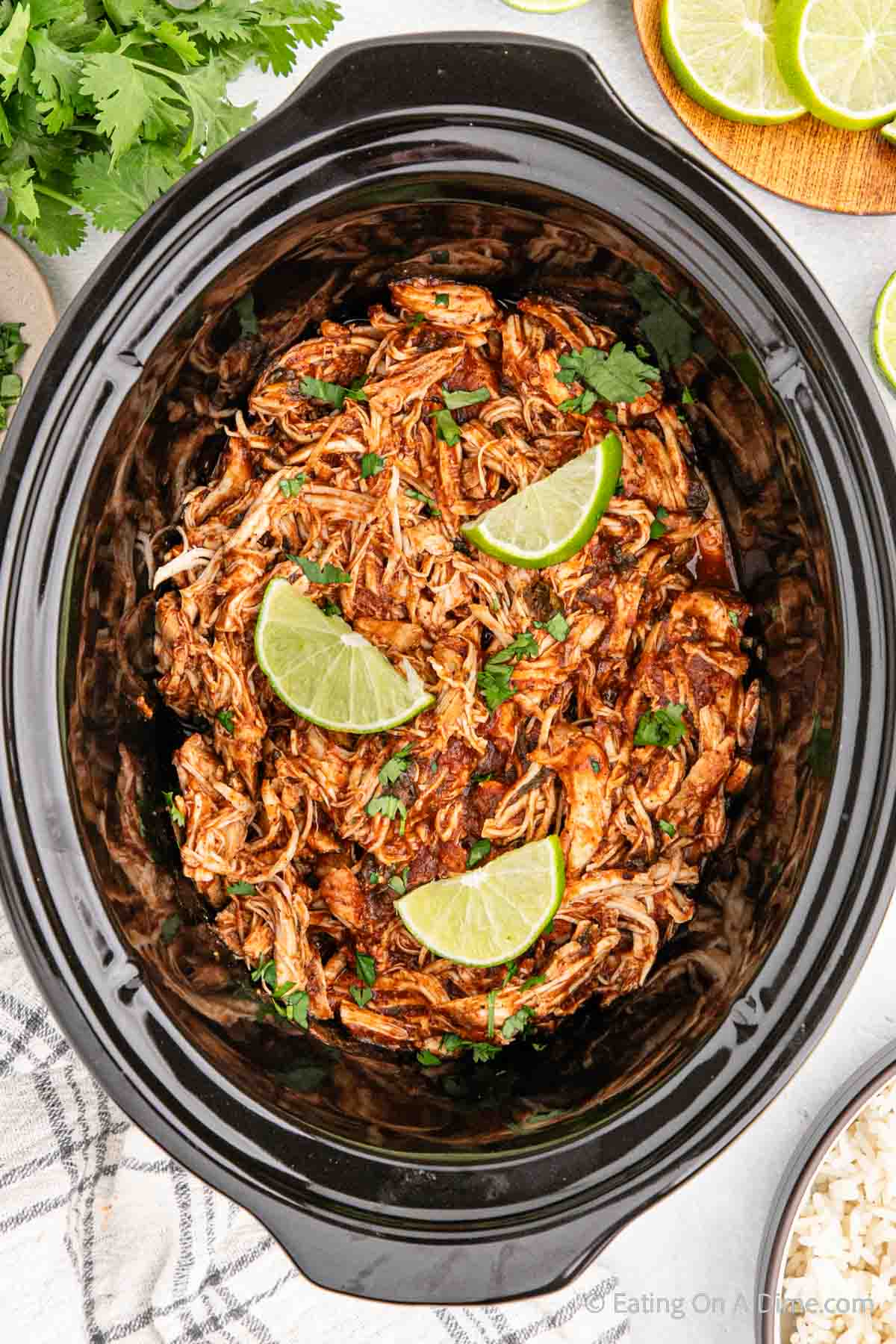 Cilantro lime chicken in the slow cooker topped with lime wedges
