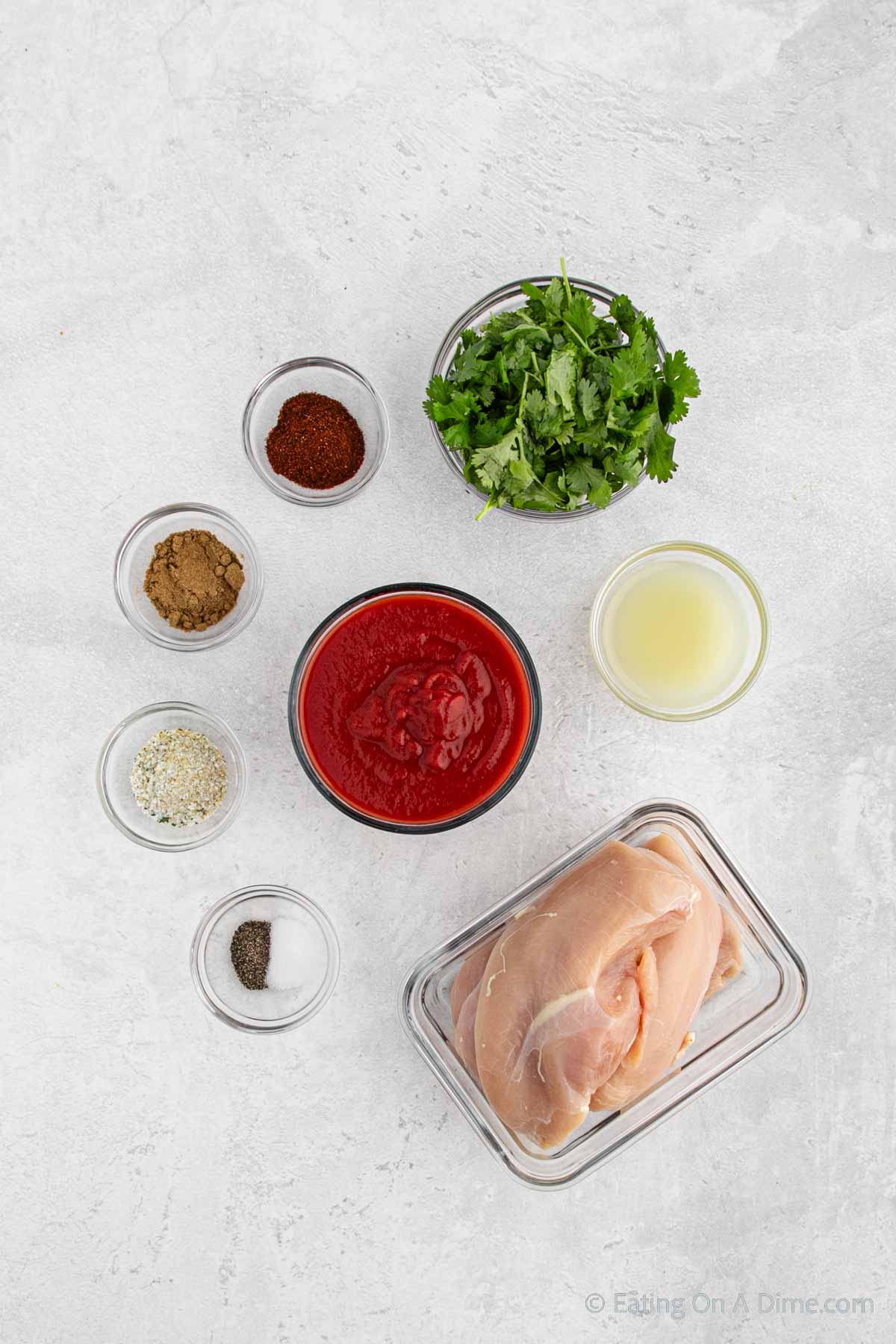 Cilantro Chicken ingredients - chicken breasts, tomato sauce, fresh cilantro, fresh lime, chili powder, cumin, garlic salt, salt and pepper