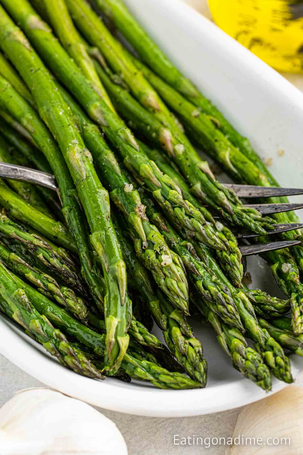 Roasted Asparagus in a serving dish with a fork